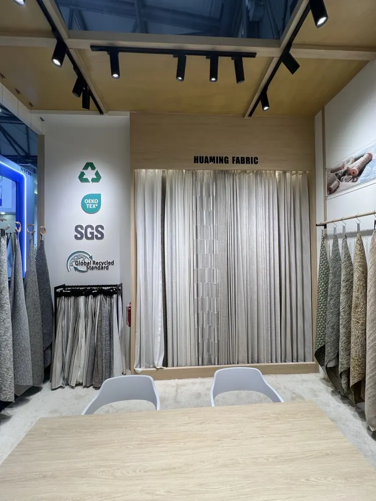 Huaming booth corner with OEKO-TEX and SGS certification marks, Shanghai 2026