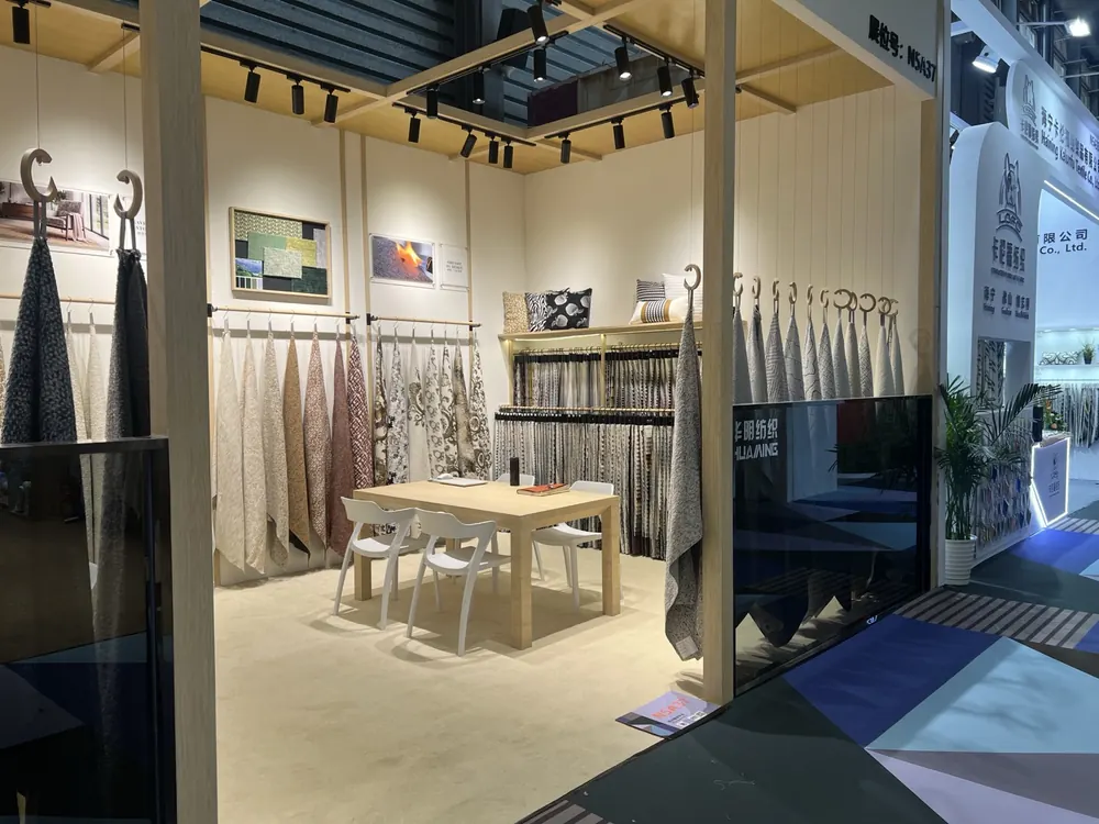 Meeting table with fabric swatch walls inside the Huaming booth, Shanghai 2026