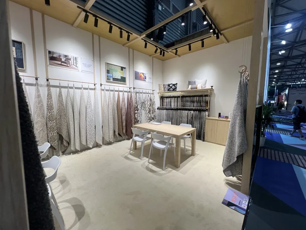 Wide view of the Huaming booth with WEAVE NATURE INTO HOME sign, Shanghai 2026