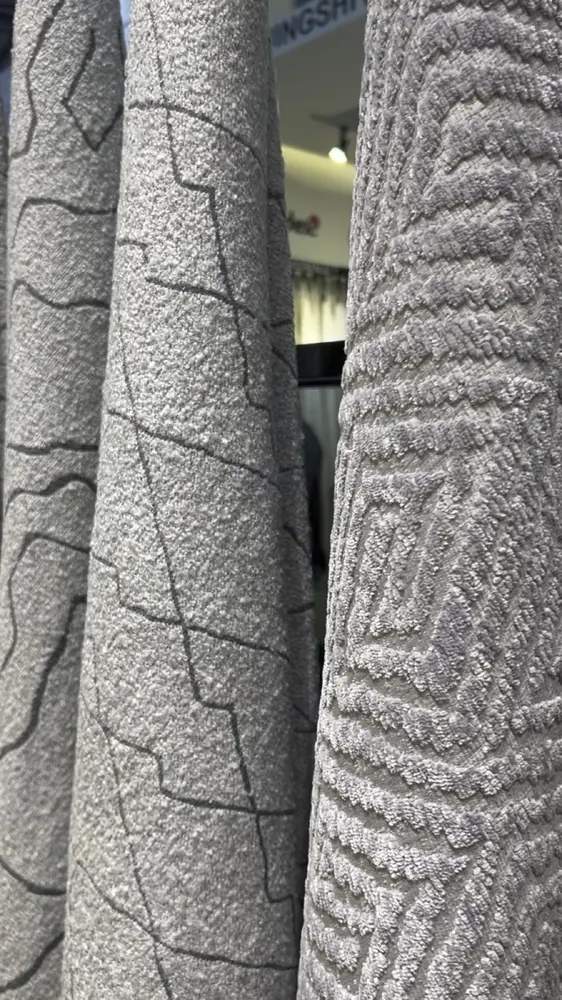 Grey chenille boucle upholstery fabric texture, embossed weave (video still)