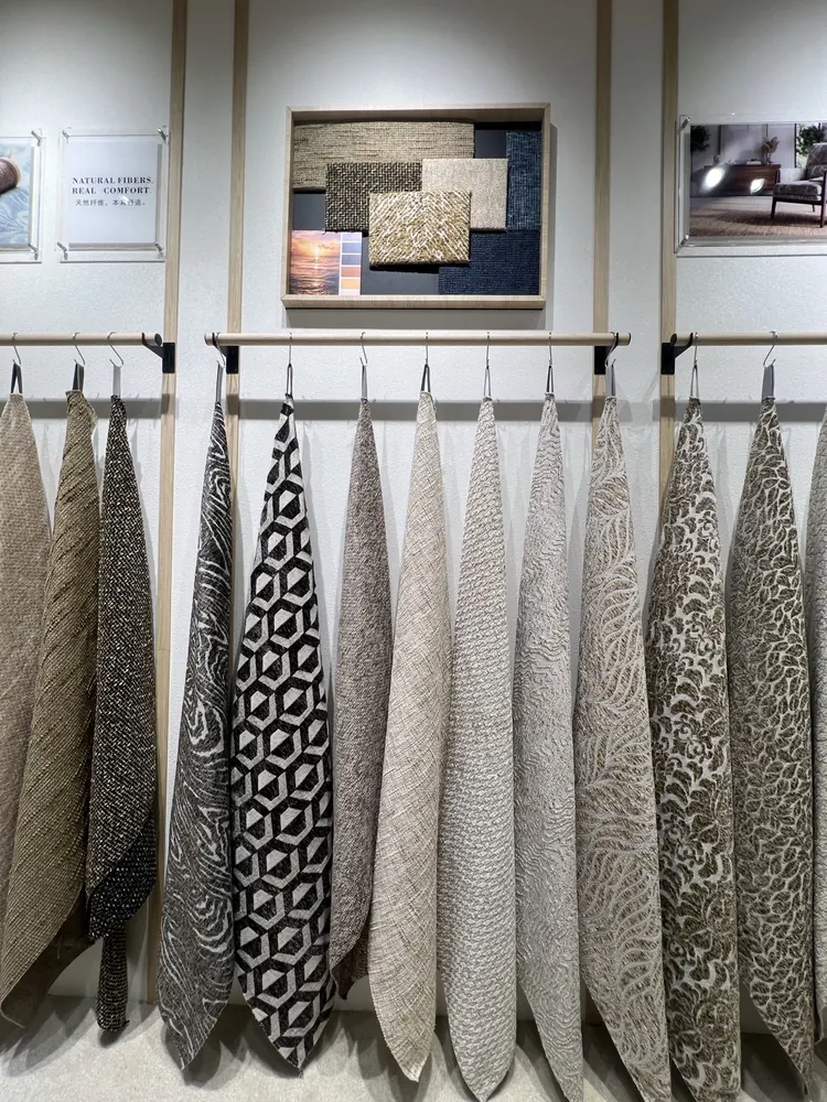 Rows of upholstery swatches on the Huaming sample wall, Shanghai furniture fair 2026
