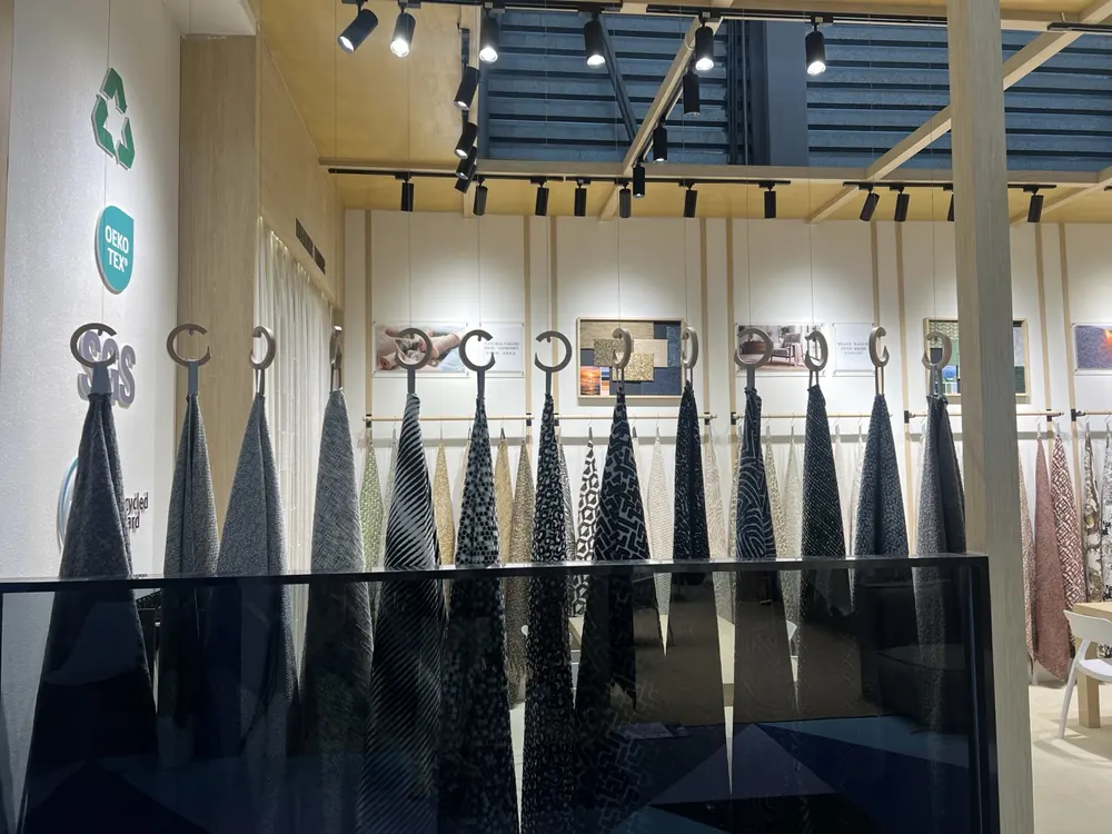 Hanging upholstery swatch wall with OEKO-TEX certification graphics, Huaming booth