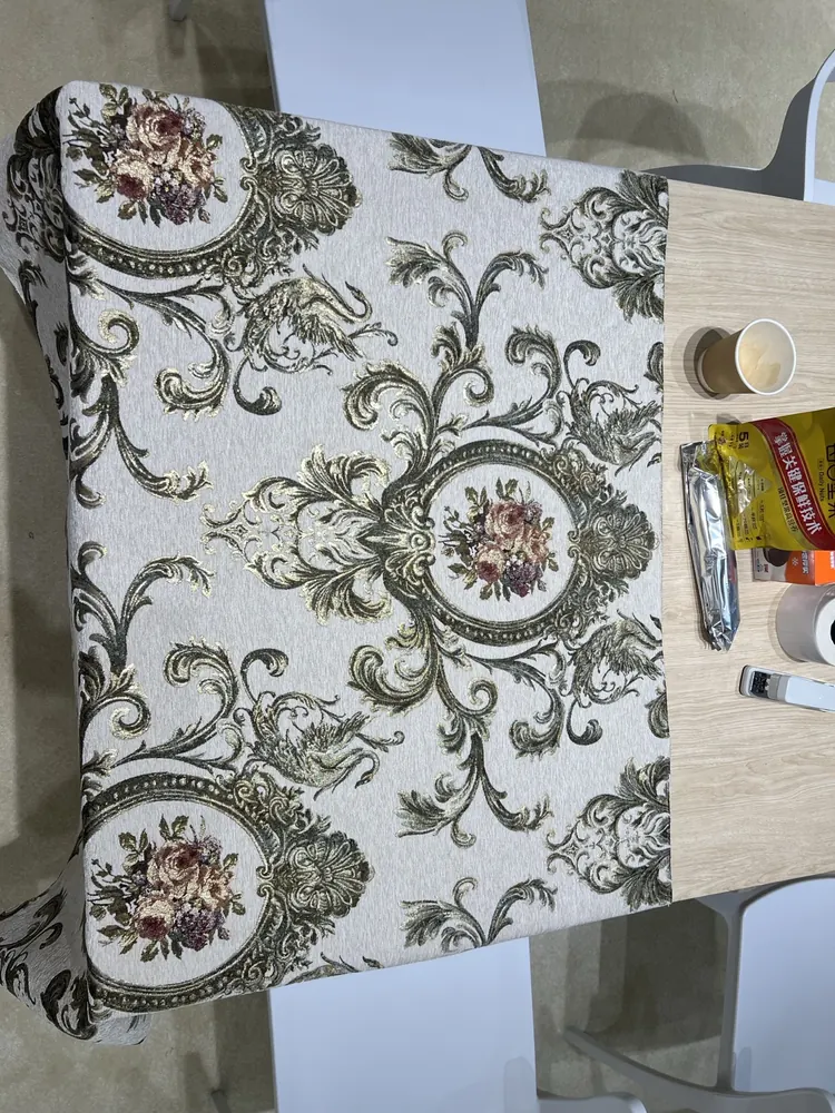 Gold and green jacquard damask upholstery fabric on the Huaming booth table